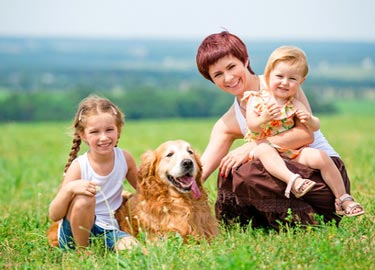 Young mother with children and dog